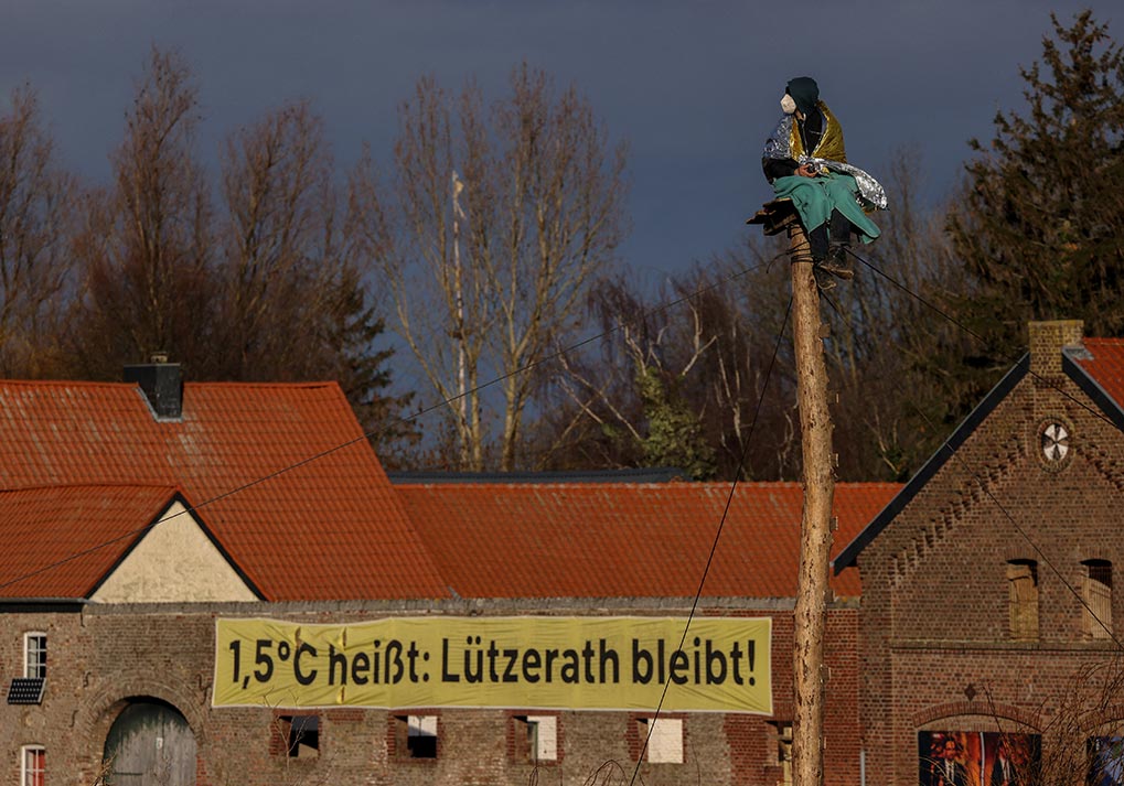 4/10&emsp;&emsp;&emsp;&emsp;Activist stands guard at Luetzerath, 2023.