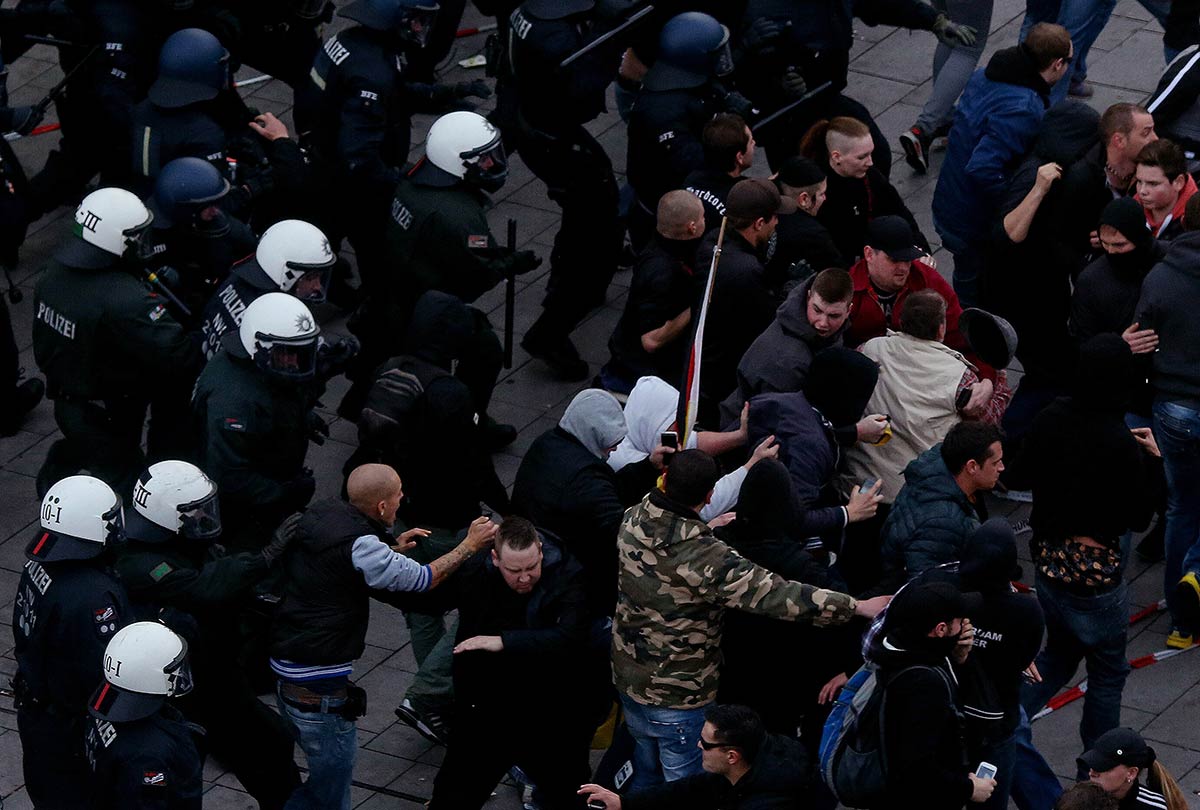 2/4&emsp;&emsp;&emsp;&emsp;Far-right demonstrators turn over a police van during riots in Cologne, 2014