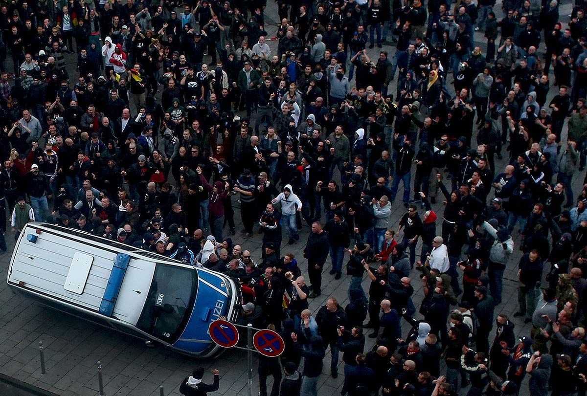 3/4&emsp;&emsp;&emsp;&emsp;Far-right demonstrators turn over a police van during riots in Cologne, 2014
