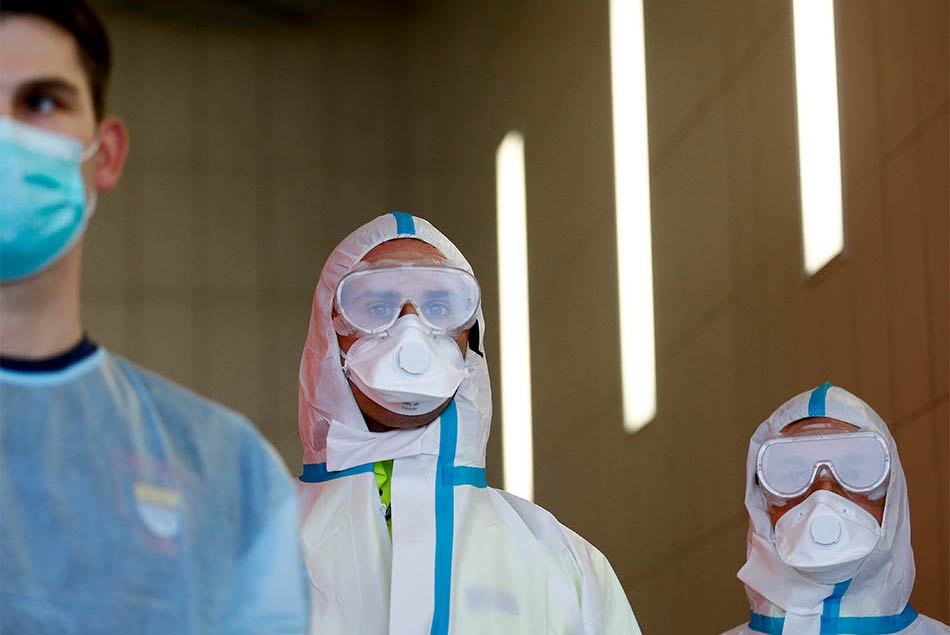 3/10&emsp;&emsp;&emsp;&emsp;Members of rescue services admit the spread of the coronavirus disease in Cologne, Germany, March 19, 2020